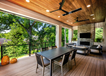 Covered outdoor dining and lounge overlooking the tree canopy
