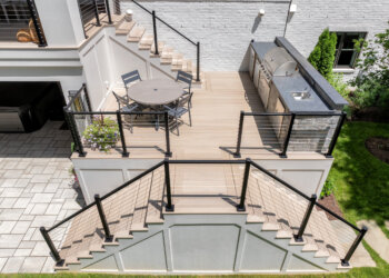 Terrace outdoor kitchen and dining deck connected by cable-railed stairs