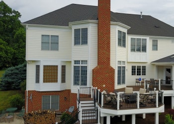 Wide view of a custom multi-level deck and covered outdoor living area.