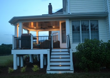Wood deck stairs with custom railings and landscape lighting.