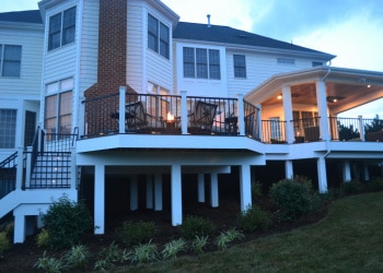 Middle level of a custom wood deck with railings.