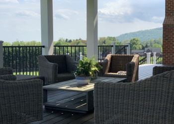 Covered porch seating area and adjoining deck.