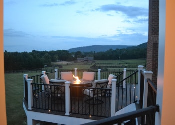Twilight view of a fire pit and deck seating.
