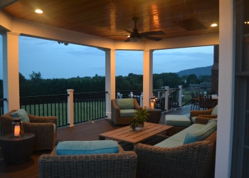 Blue-hour outdoor seating area under a covered porch.
