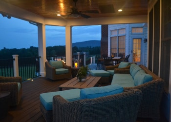 Illuminated custom porch lounge at twilight.