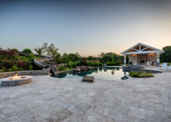 Travertine terrace freeform pool waterslide spa and pavilion in the Purcellville outdoor living retreat