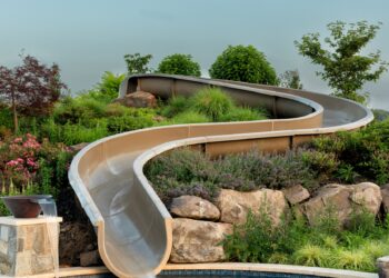 Portrait view of the landscaped waterslide descending into the pool
