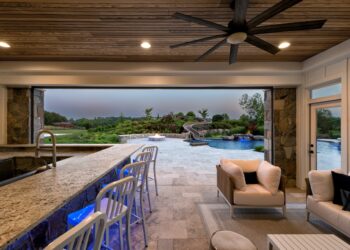 Open-air pool house lounge and bar overlooking the waterslide and pool