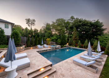 Terraced poolscape with layered stone steps and contemporary cable railing