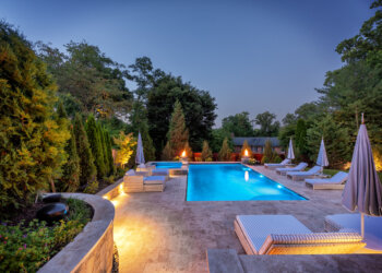 Illuminated pool and fire-bowl detail at twilight