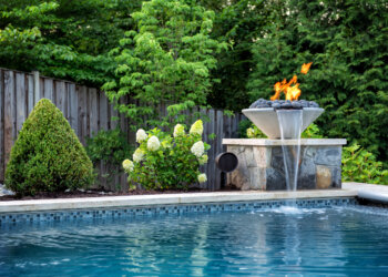 Twilight poolside view with luminous water and tailored landscape planting