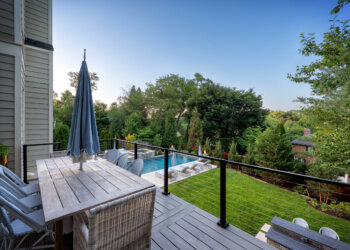 Elevated deck view toward the pool spa and mature landscape