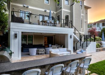 Aerial view of the outdoor kitchen covered living space and terraced poolscape