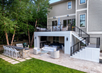 Poolside outdoor kitchen and covered living space with cable railing