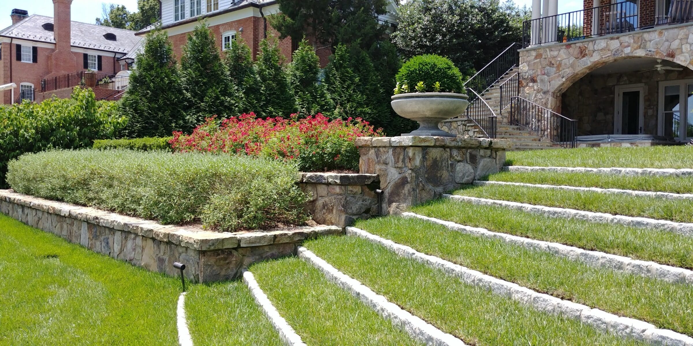 Stone turf steps, retaining walls, and planting beds at Potomac Georgian Entry.